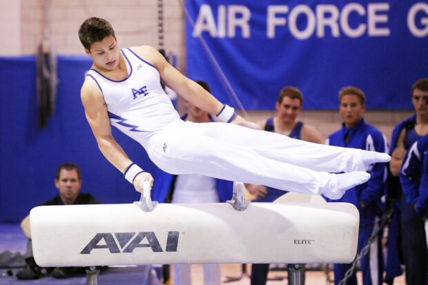 Male athlete training on pommel horse in acrobatic gymnastics competition, HD Desktop Wallpaper
