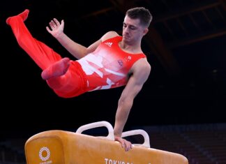 A male gymnast is captured mid routine on the pommel horse gymnastics apparatus, 2K Desktop Wallpaper
