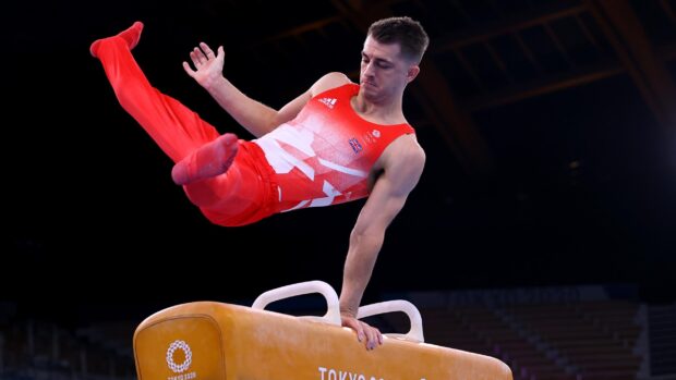 A male gymnast is captured mid routine on the pommel horse gymnastics apparatus, 2K Desktop Wallpaper