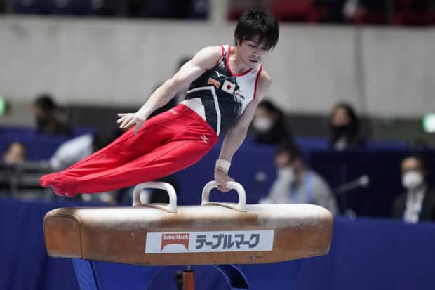 Male gymnast performing on pommel horse during a gymnastics competition, HD Desktop Wallpaper