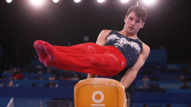A male gymnast performing a pommel horse routine during a competition, HD Desktop Wallpaper