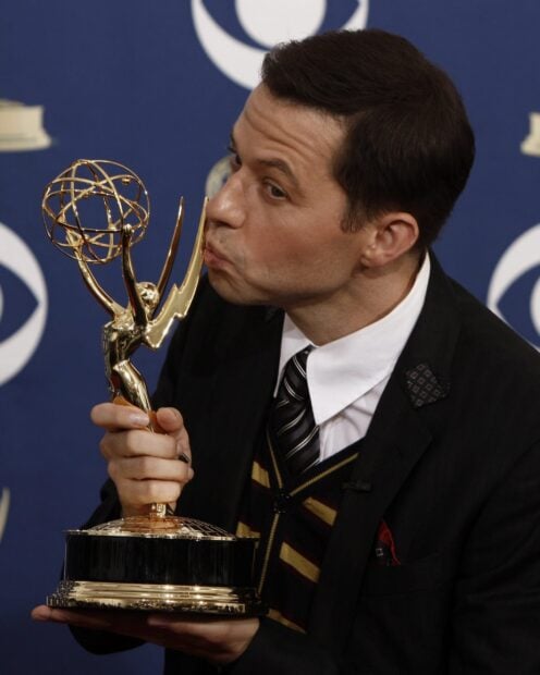 A man kissing an Emmy Awards trophy at a press event, 2K Mobile Wallpaper