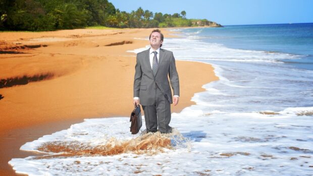 A man in a suit is standing in the ocean on a tropical beach from Death In Paradise Tv Series, HD Desktop Wallpaper
