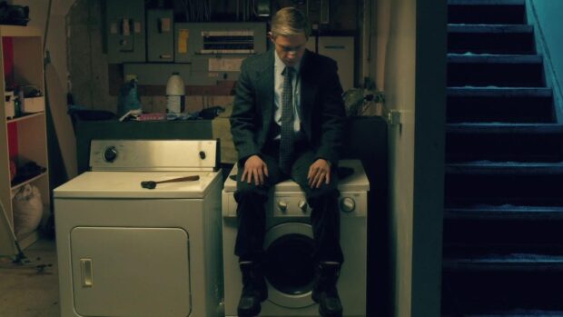 A man in a suit sits on a washing machine in a dimly lit basement room reflecting deep thought with Fargo Wallpapers, HD Desktop Wallpaper