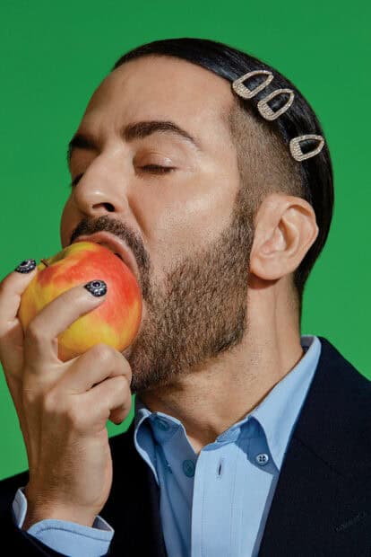 A man with hair clips bites a red and yellow apple with closed eyes in a close up portrait for Marc Jacobs Wallpapers, HD Mobile Wallpaper