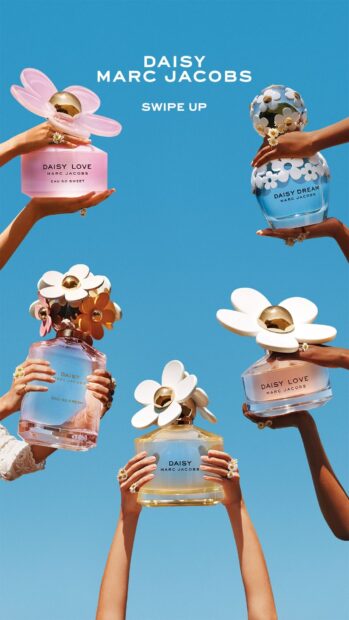 Hands holding various Marc Jacobs perfume bottles against blue sky, HD Phone Wallpaper