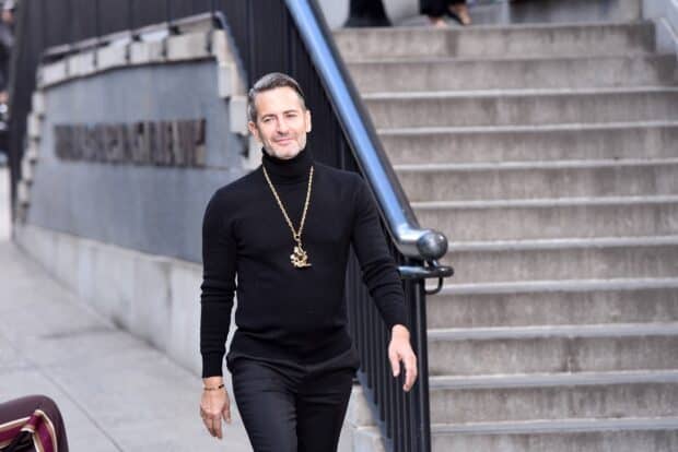 A man wearing a black turtleneck and gold necklace walking near stairs in the city with Marc Jacobs style, HD Desktop Wallpaper