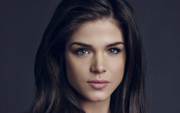The portrait shows Marie Avgeropoulos with focused expression and clear eyes, 2K Desktop Wallpaper
