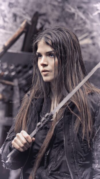 Marie Avgeropoulos is gripping a sword with determination in a rugged outfit, 2K Mobile Wallpaper
