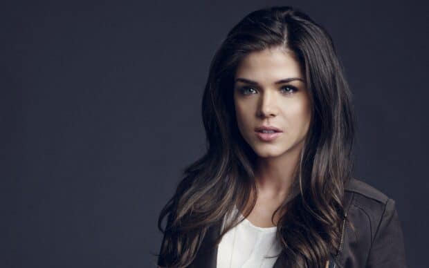 A close up portrait of Marie Avgeropoulos with long hair and a serious expression, 2K Desktop Wallpaper