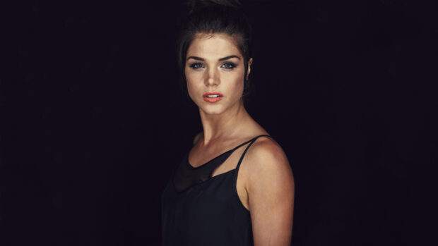 A close up portrait of Marie Avgeropoulos wearing a black top with a dark background, 4K Desktop Wallpaper