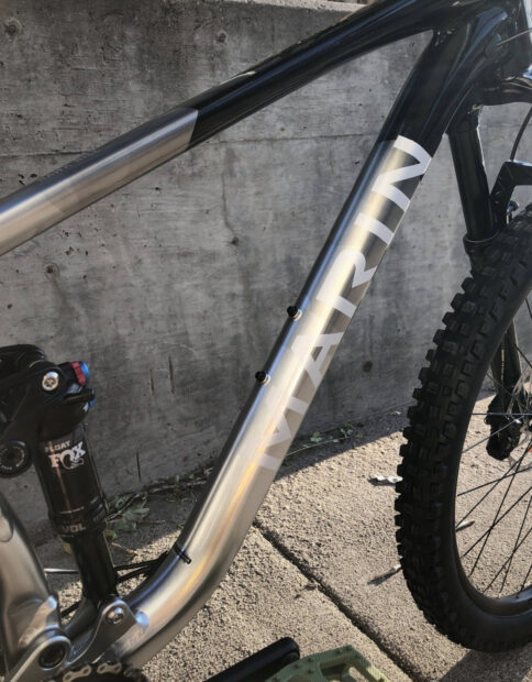 A close up view of the Marin Bikes mountain bike frame and tire, HD Mobile Wallpaper