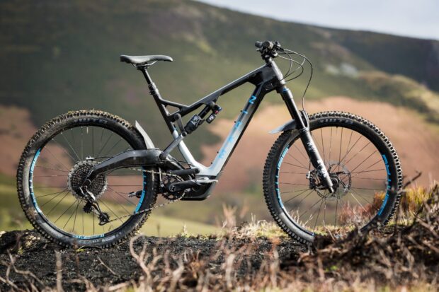 A black and blue Marin bike is positioned on rugged terrain with hills in the background, HD Desktop Wallpaper