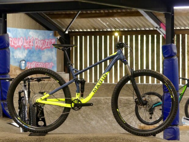 A Marin Bikes Wallpapers mountain bike stands ready in an indoor bike park with graffiti walls, HD Desktop Wallpaper