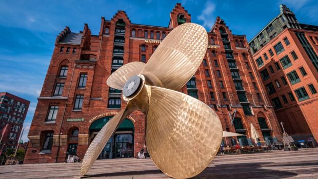 The large brass propeller sculpture stands in front of the Maritime Museum building, HD Desktop Wallpaper