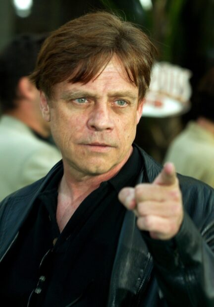 Mark Hamill points forward with focused expression in a crowd, HD Mobile Wallpaper