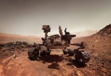 The Mars Curiosity Rover explores rocky terrain on Mars with detailed instruments and wheels, 2K Desktop Wallpaper