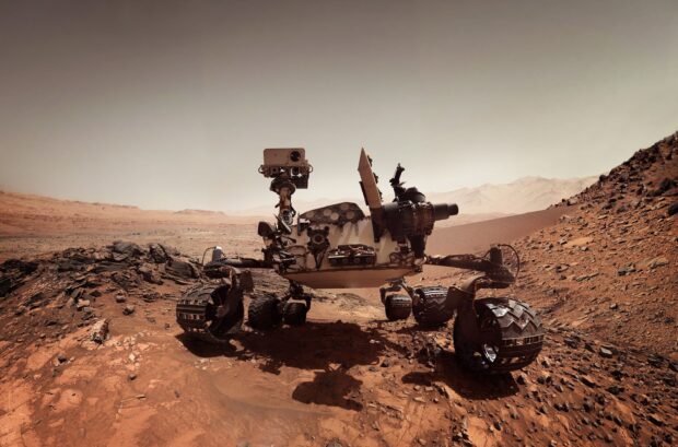 The Mars Curiosity Rover explores rocky terrain on Mars with detailed instruments and wheels, 2K Desktop Wallpaper