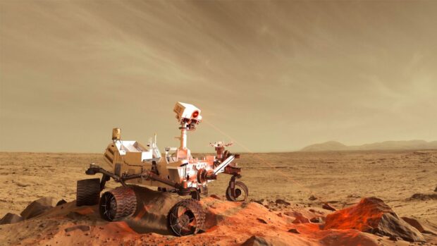 The Mars Curiosity Rover is operating on a rocky surface under a hazy sky, HD Desktop Wallpaper