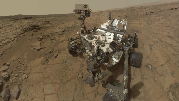 The Mars Curiosity Rover is captured on the red rocky terrain of Mars in this detailed photo, 2K Desktop Wallpaper