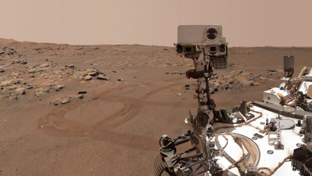 The Mars Curiosity Rover is shown navigating rocky plains on the surface of Mars, 4K Desktop Wallpaper