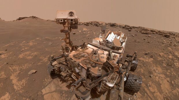 The Mars Curiosity Rover explores the rocky terrain of Mars in this detailed image, 2K Desktop Wallpaper