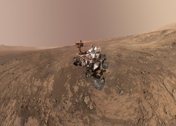 The Mars Curiosity Rover explores rocky terrain under a dusty Martian sky, 2K Desktop Wallpaper