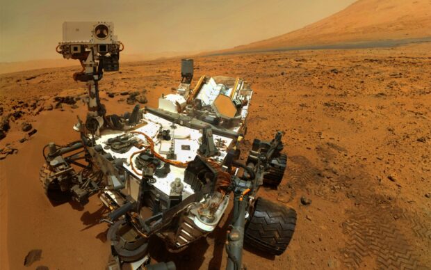 The Mars Curiosity Rover exploring the red planet surface with rocky terrain around, 2K Desktop Wallpaper