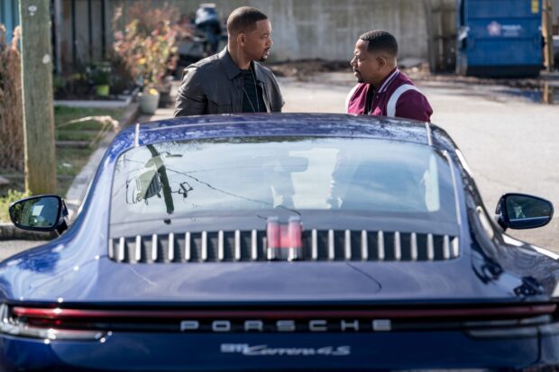 Martin Lawrence and Will Smith stand beside a blue Porsche in a street scene, 2K Desktop Wallpaper