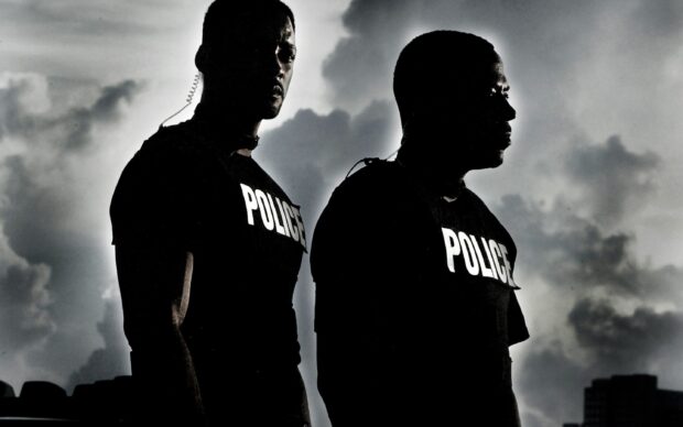 Martin Lawrence and a companion are seen in police uniforms under a cloudy sky, 2K Desktop Wallpaper