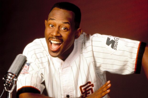 Martin Lawrence smiling and speaking into a microphone in a white sports jersey, HD Desktop Wallpaper