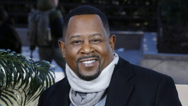 Martin Lawrence is smiling warmly outdoors in a casual coat and scarf, 2K Desktop Wallpaper