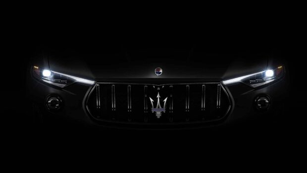 The close up of Maserati Levante displays the illuminated headlights and front grille, HD Desktop Wallpaper