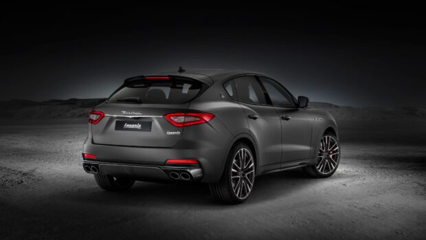A stylish Maserati Levante is shown from the rear on a dimly lit surface, highlighting its design, 4K Desktop Wallpaper