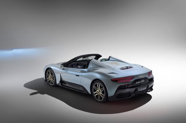A sleek light blue Maserati MC20 sports car is shown from the rear in a studio, 2K Desktop Wallpaper