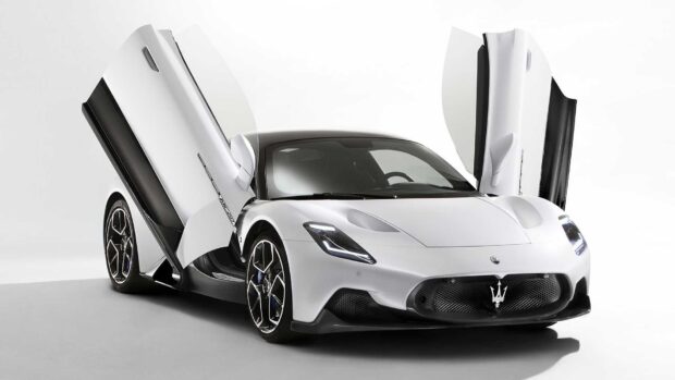 A white Maserati MC20 sports car is shown with butterfly doors open in a studio setting, HD Desktop Wallpaper