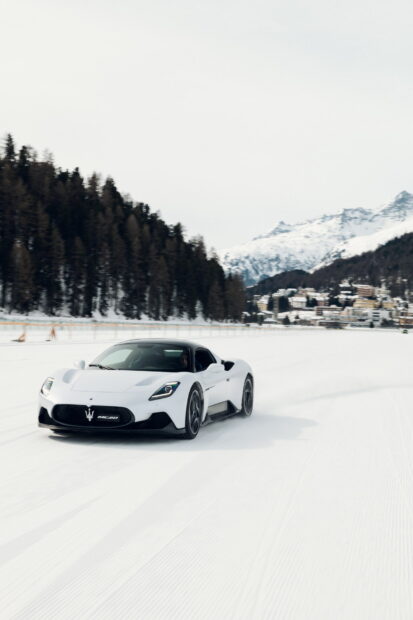 A white Maserati Mc20 driving on a snowy road with trees and mountains in the background, HD Mobile Wallpaper