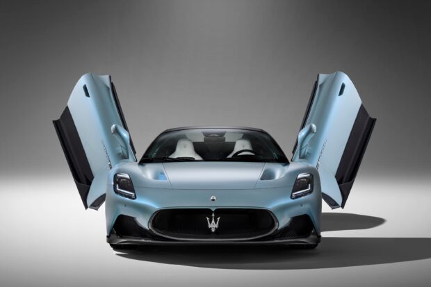 A Maserati Mc20 sports car with butterfly doors opened in a studio setting, 2K Desktop Wallpaper