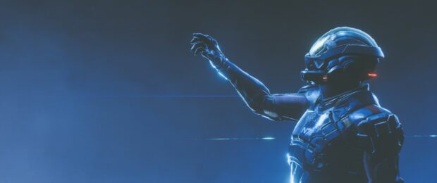 A character wearing a futuristic space suit reaching out with a glowing blue light in Mass Effect Andromeda, 2K Desktop Wallpaper