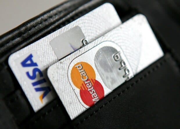A close up view of Mastercard and Visa cards inside a black wallet showing the logos clearly, HD Desktop Wallpaper