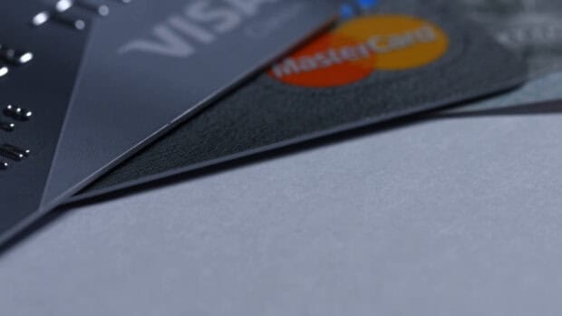 A close up view of multiple credit cards including Mastercard on a gray surface, 4K Desktop Wallpaper