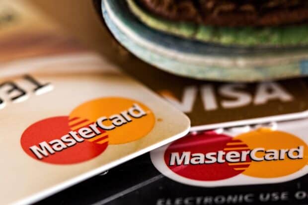 A close up of Mastercard logos on two cards with a blurred Visa card in the background, HD Desktop Wallpaper