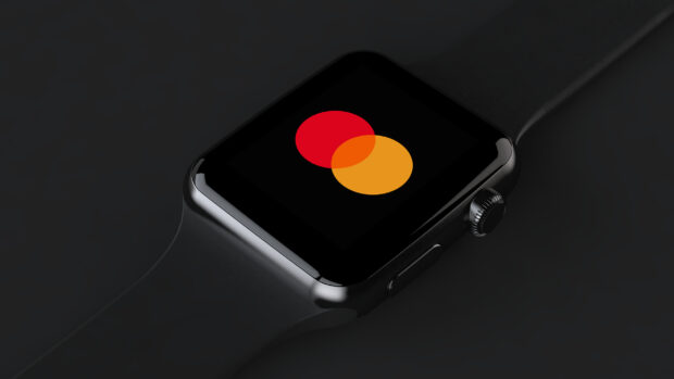 A close up of a smartwatch displaying the Mastercard logo on its screen, 2K Mobile Wallpaper