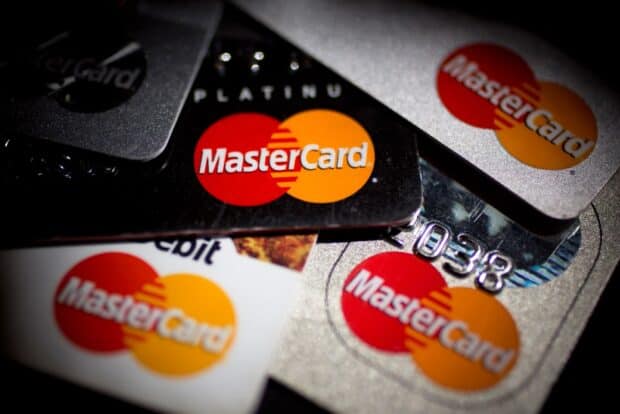 Various Mastercard logos displayed on a collection of credit cards, HD Desktop Wallpaper