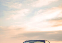 A matte purple Subaru Brz is parked on a concrete surface with a cloudy sky at sunset, 2K Mobile Wallpaper