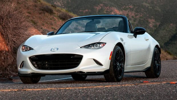 A white Mazda MX 5 Miata is parked on a winding mountain road with rocky hills in the background, HD Desktop Wallpaper