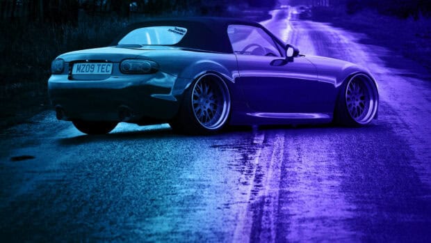 A Mazda MX 5 Miata is parked on a textured road with blue and purple lighting, HD Desktop Wallpaper