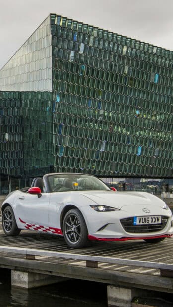 A white Mazda MX 5 Miata is parked in front of a modern glass building, HD Phone Wallpaper