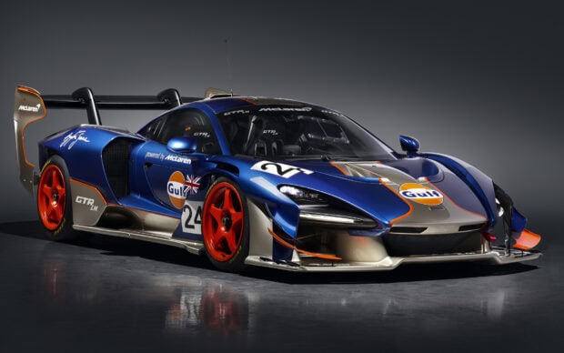 A blue and orange McLaren Senna race car with sporty decals on a gray background, HD Desktop Wallpaper