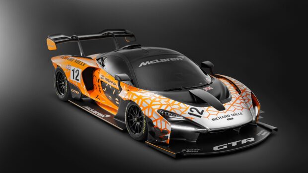 A McLaren Senna car with orange and black racing graphics on a dark background, 4K Desktop Wallpaper